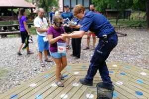 Policjantka pomaga dziewczynce podczas konkurencji