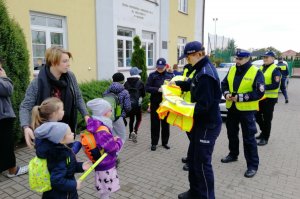 Policjanci rozdają odblaskowe kamizelki