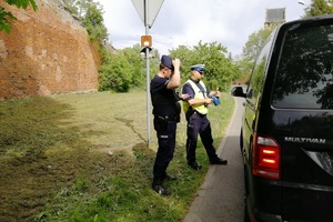 Policjanci kontrolują zatrzymanego kierowcę