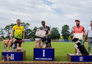 Zawodnicy, wraz z pupilami stoją na podium