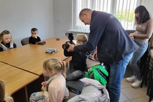 Policjanci goszczą na terenie komendy przedszkolaków, którym pokazują miejsce swojej codziennej służby