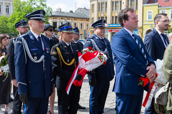 Delegacja służb mundurowych oczekuje na złożenie wiązanki przy pomniku