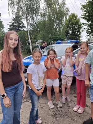 Policjanci prowadzą spotkanie edukacyjne z półkolonistami