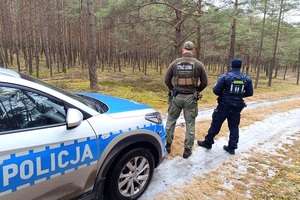 Policjant i Strażnik Leśny sprawdzają las.