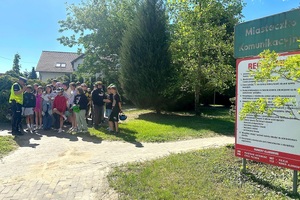 Policjant ruchu drogowego rozmawia z dziećmi i egzaminuje ich na kartę rowerową