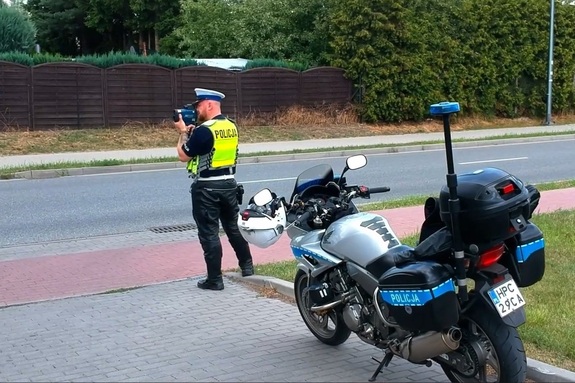 Policjant kontroluje prędkość z miernikiem prędkości
